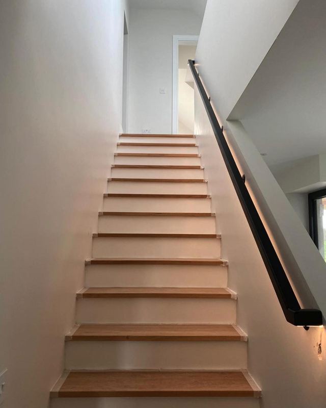 Contemporary staircase — White oak treads · black handrail with LED
